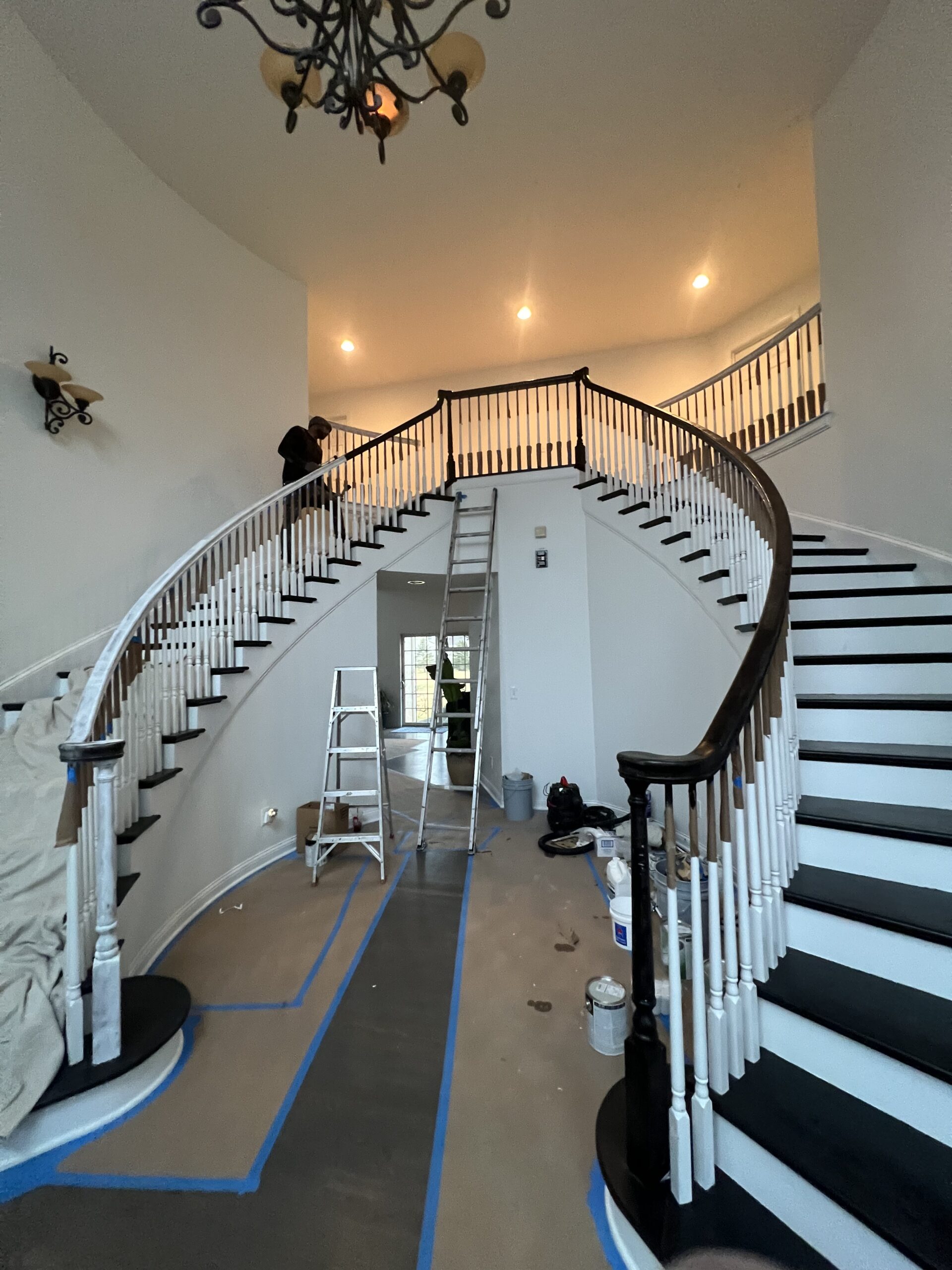 Painting professional using roller inside modern Hilliard home