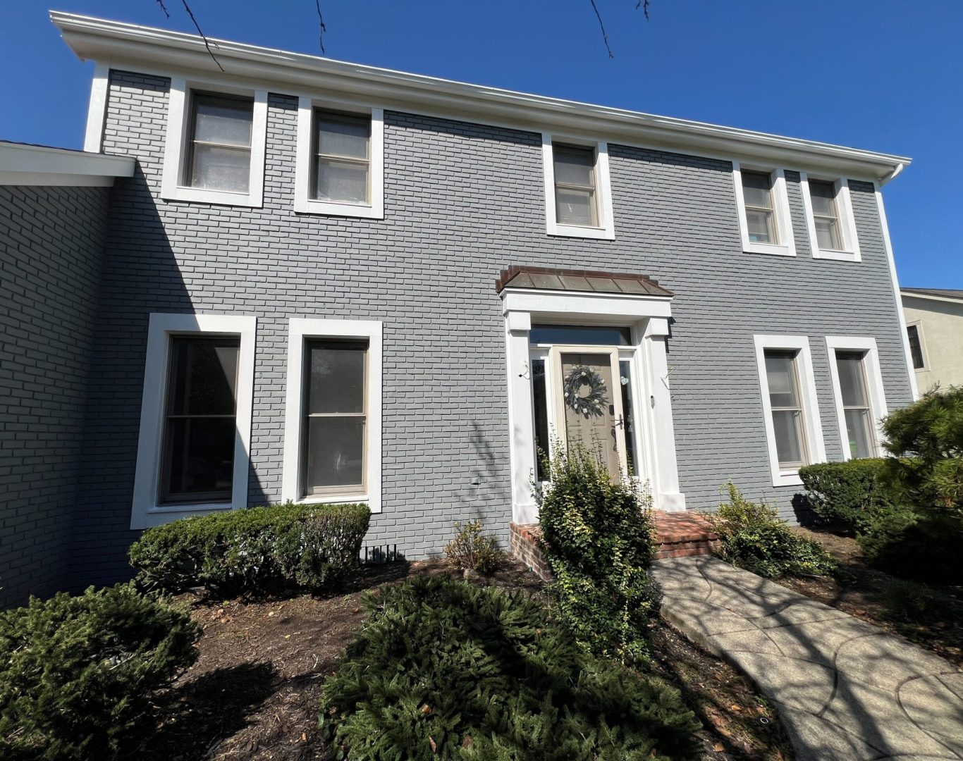 Professional commercial painters working on exterior building in downtown area