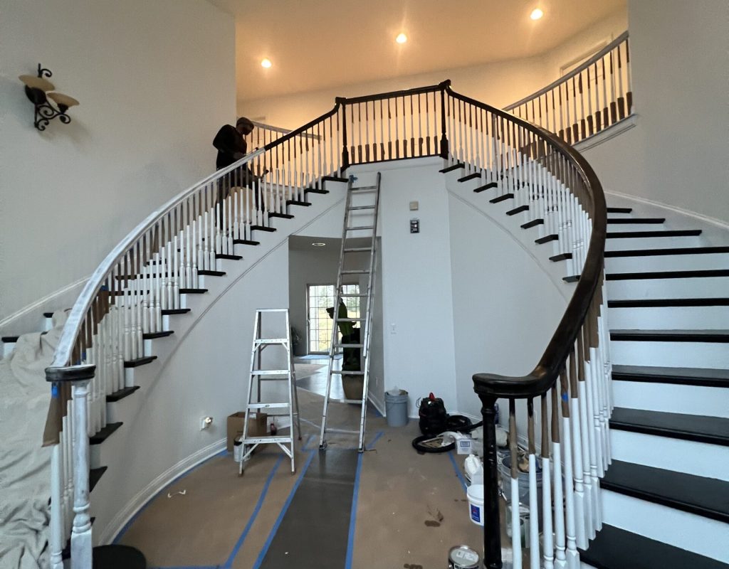 Painting professional using roller inside modern Hilliard home
