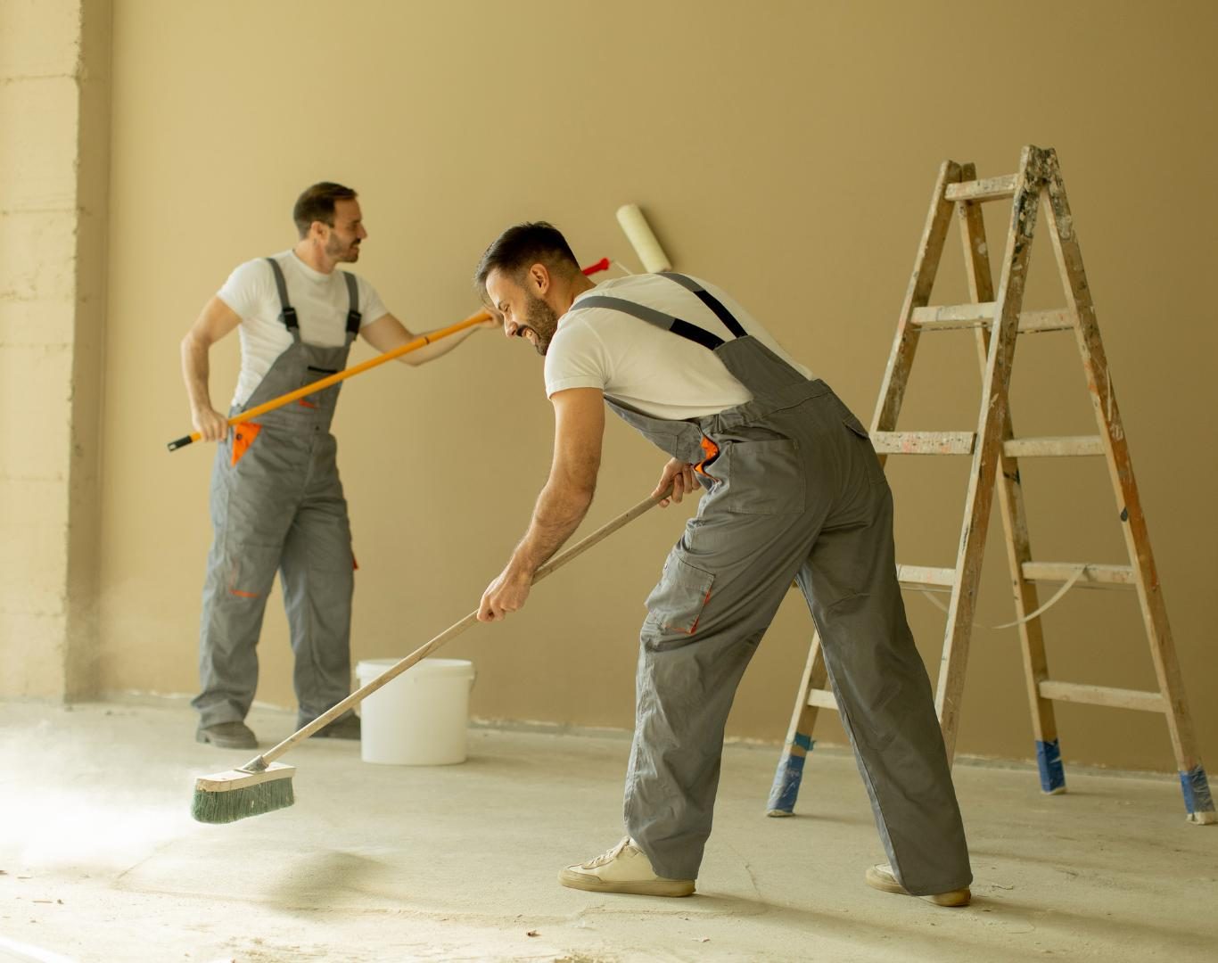Painter prepping walls in occupied Dublin home before applying fresh interior living room paint