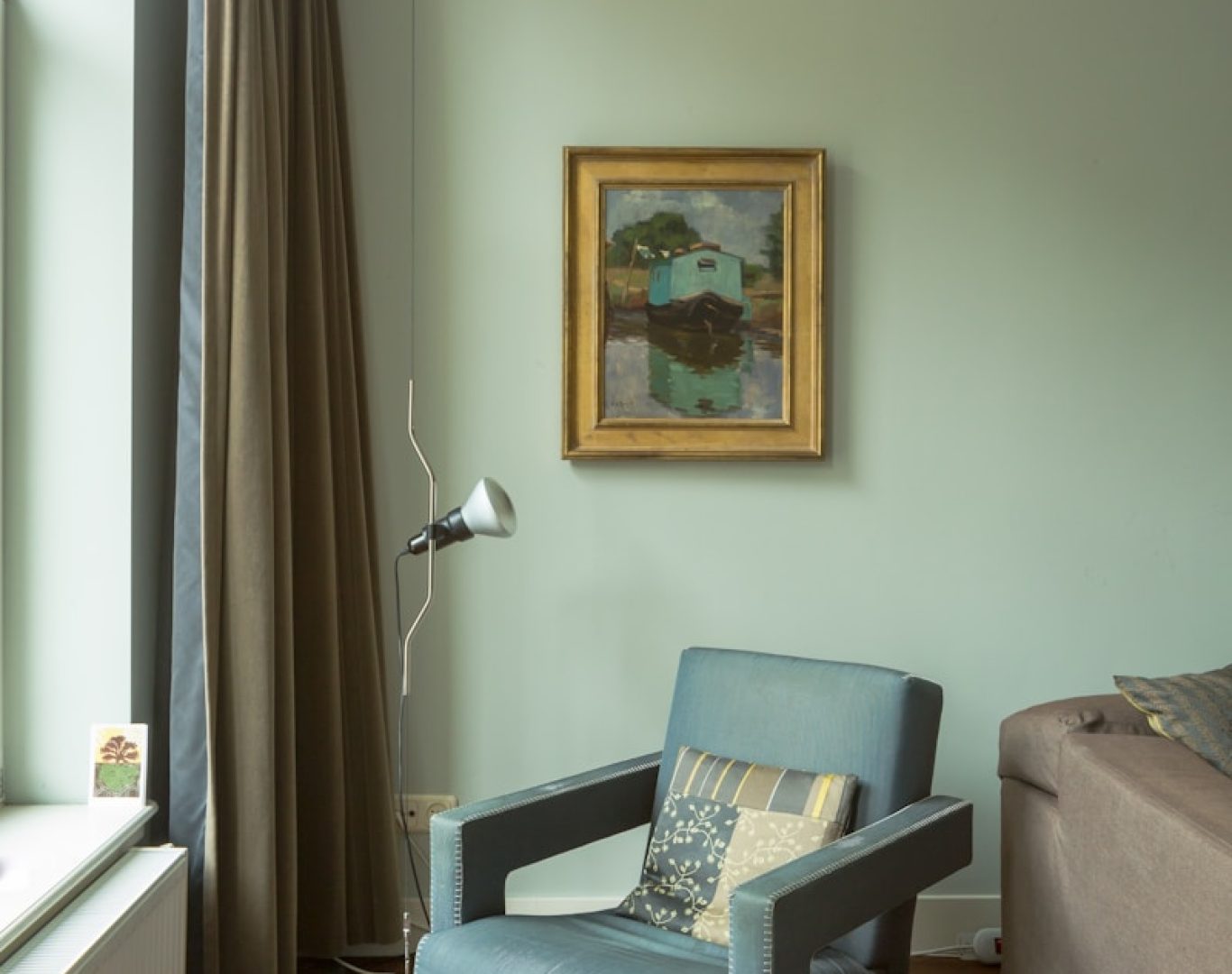 gray sofa chair beside window